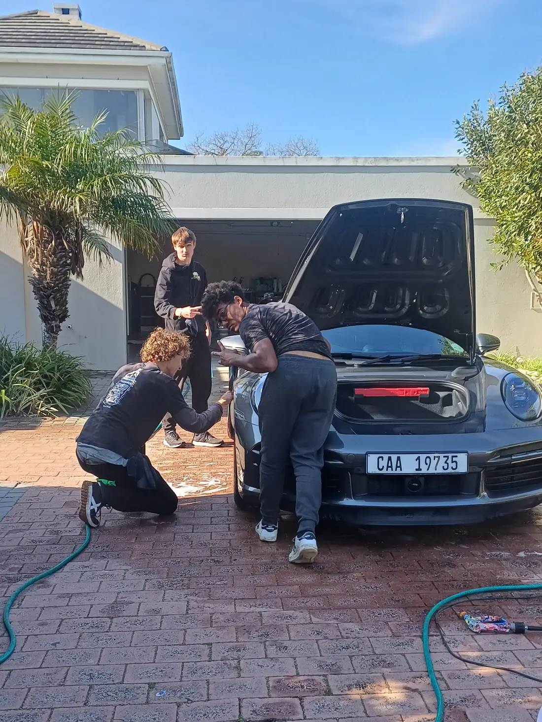 Cape Auto Detailing team washing a Porsche 911 Turbo